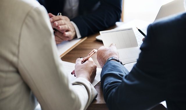 Closeup of meeting with men dressed in professional attire